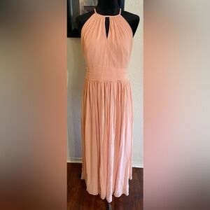 Peach colored formal dress.